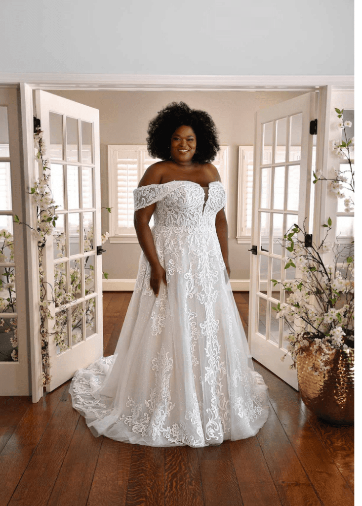 bride wearing off the shoulder lace plus size wedding dress