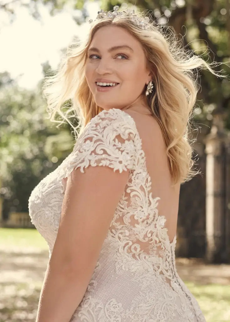 Beautiful bride wearing low back plus size wedding dress by Maggie Sottero