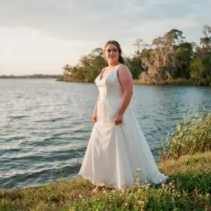 Plus size wedding dresses on the Grand Strand: bride in a fitted gown at the Lowcountry shoreline near Pawleys Island.